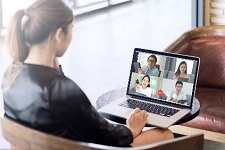 Person viewing laptop during virtual meeting
